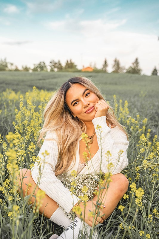 Adelaine Morin posing for a photoshoot  in a mustard field